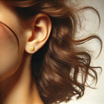 Image showing a model wearing gold cat head stud earring.