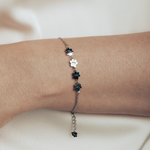 A model is wearing silver bracelet featuring four cute kitty paws.