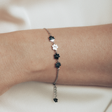 A model is wearing silver bracelet featuring four cute kitty paws.