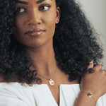 Close-up of model showcasing gold cat head necklace with heart detail, perfect for everyday wear.