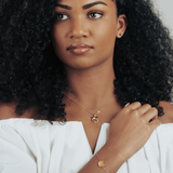 Gold cat head pendant with a heart detail, worn by model for a minimal and timeless look.