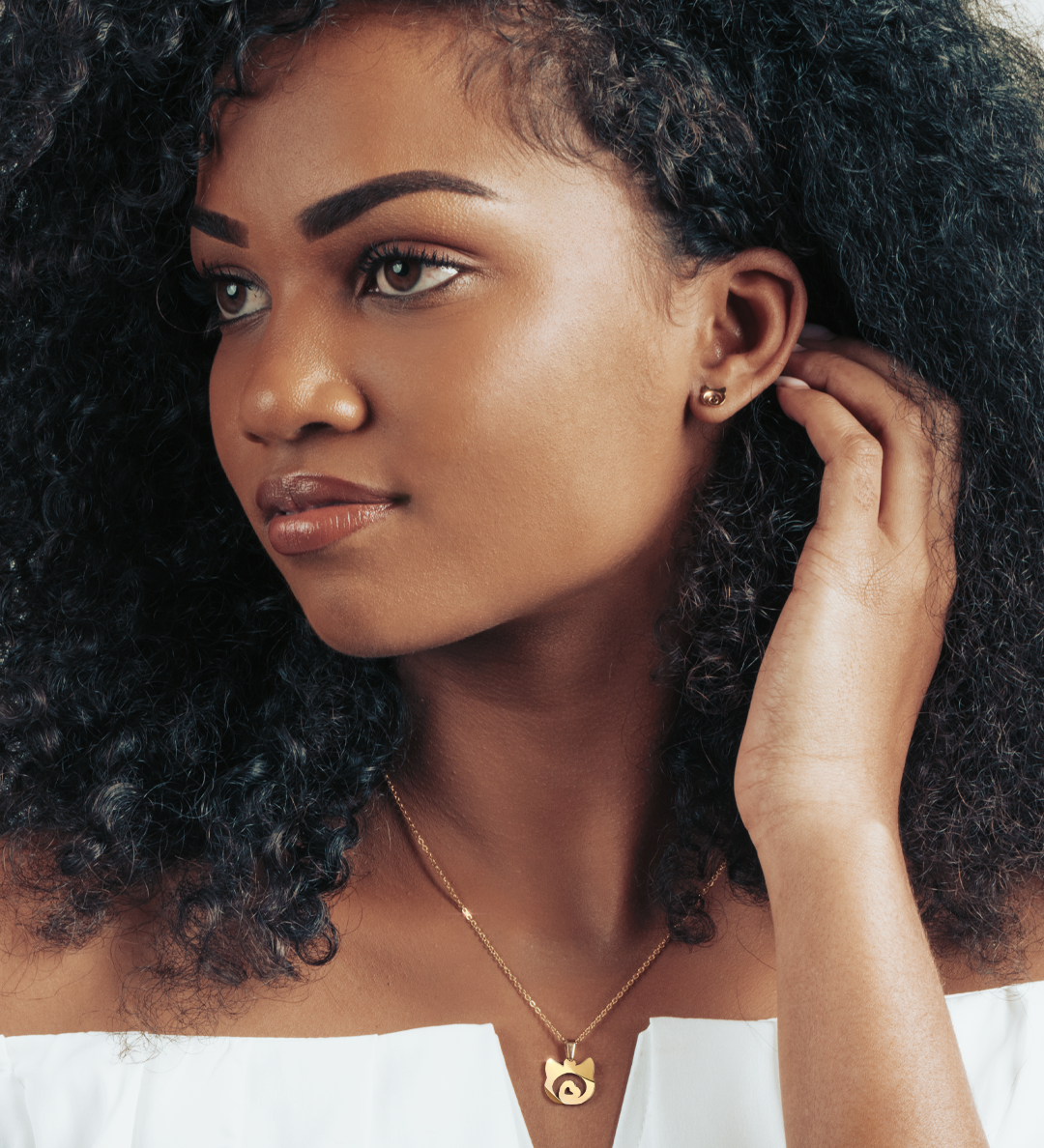 Model wearing a gold cat pendant, a subtle and elegant way to show feline love.
