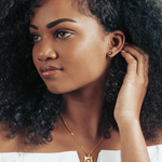 Model wearing a gold cat pendant, a subtle and elegant way to show feline love.