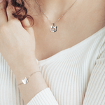 Silver cat silhouette necklace with heart detail, and a matching bracelet for a chic and timeless style.
