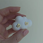 Video showing gold cat-shaped stud earrings with the little heart inside.