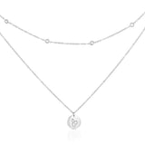Silver-tone double layer cat necklace on white, with sparkling accents on the shorter chain and a round cat-motif pendant below.