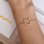 Close-up of the Magical Meow bracelet on a wrist, showing its sparkling open cat-head outline and fine chain.